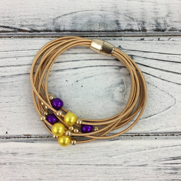 Purple and gold pearl guitar string bracelet
